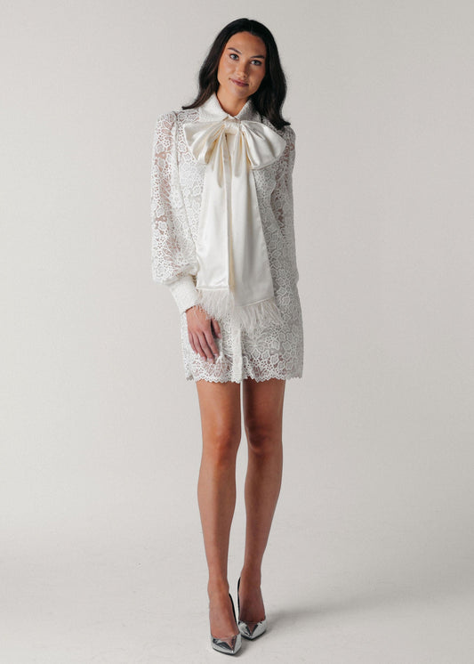 Samantha Wood Fashion Designer Bridal Era Collection Charlotte White Lace Shirt Dress on Model Front With Satin Ostrich Feather Bow