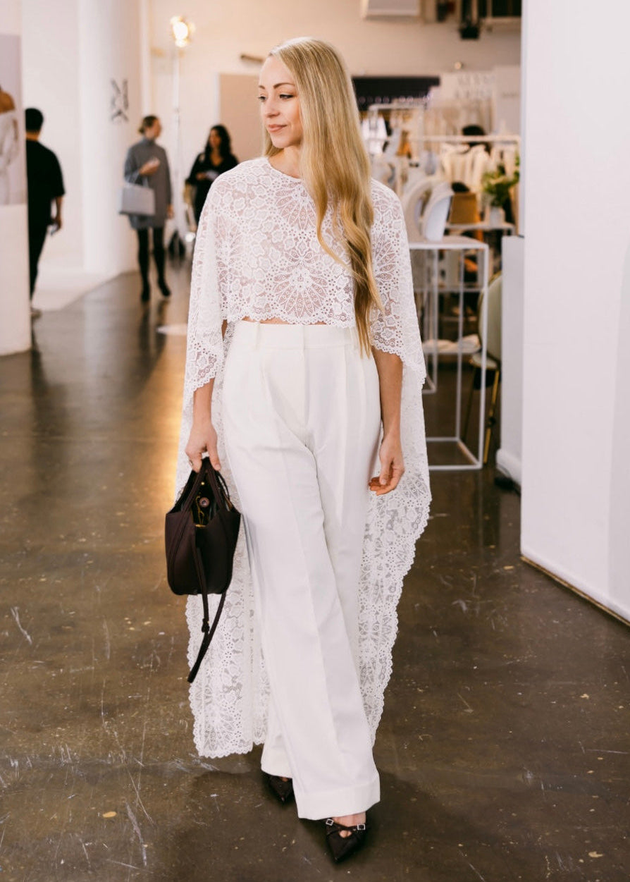 Designer Samantha Wood in Ivory White Lace Bridal Cape at New York Bridal Fashion Week styled with Favorite Daughter trousers